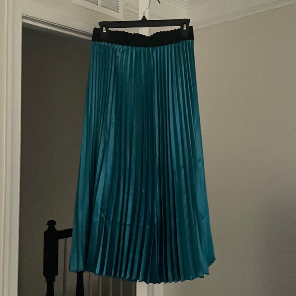 Green pleated skirt.